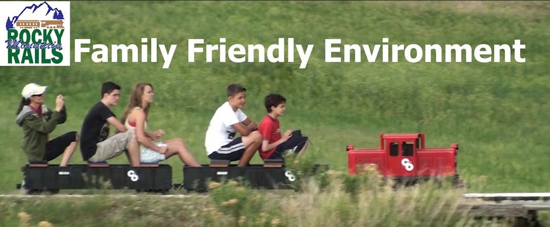 Promotional image reading 'Family Friendly Environment' above riders on a miniature train